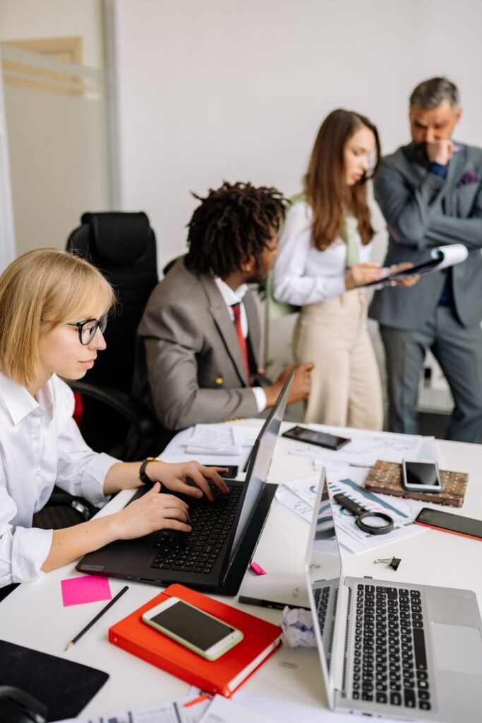 Crafting Captivating Headlines: Your awesome post title goes here Business professionals engaged in teamwork and discussion in a modern office setting.