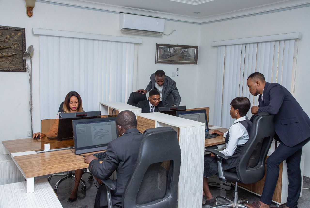 services-01 A group of professionals working together in a modern office setting, emphasizing teamwork and productivity.